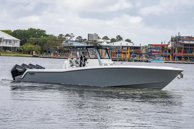 Slide: The Image of 2022 Invincible 39 Open Fisherman boat on water, featuring sleek design and powerful engines. - 13