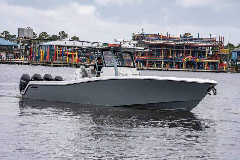 Slide: The Image of 2022 Invincible 39 Open Fisherman boat on water near colorful waterfront buildings. - 14