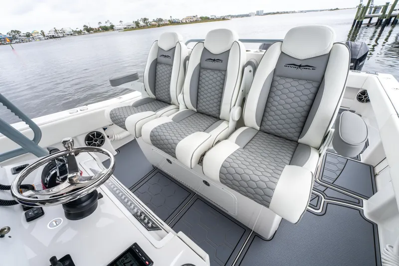 Slide: The Image of 2022 Invincible 39 Open Fisherman boat interior with luxurious seating and steering wheel. - 20
