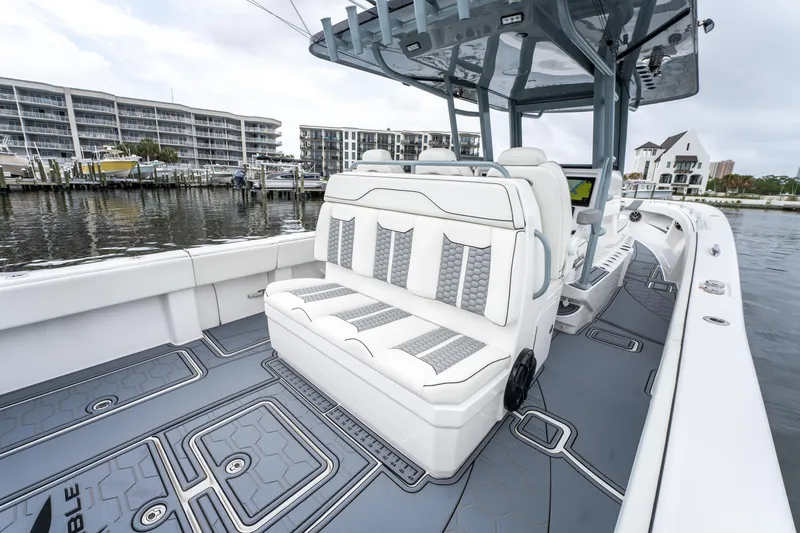 Slide: The Image of 2022 Invincible 39 Open Fisherman boat with sleek seating and modern design at a marina. - 29