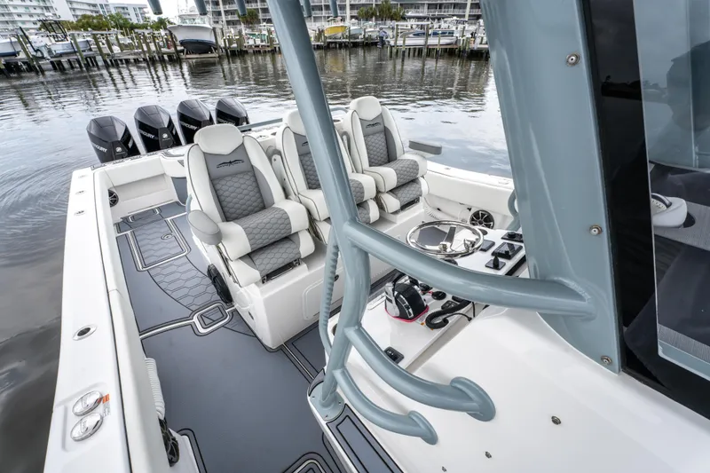 Slide: The Image of 2022 Invincible 39 Open Fisherman boat interior with luxury seating and multiple outboard engines. - 37
