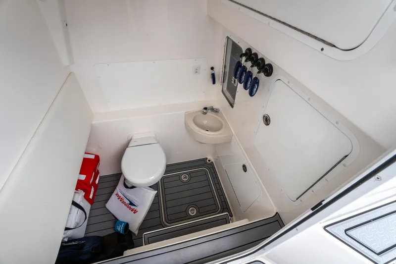 Slide: The Image of 2022 Invincible 39 Open Fisherman boat interior with compact bathroom. - 41