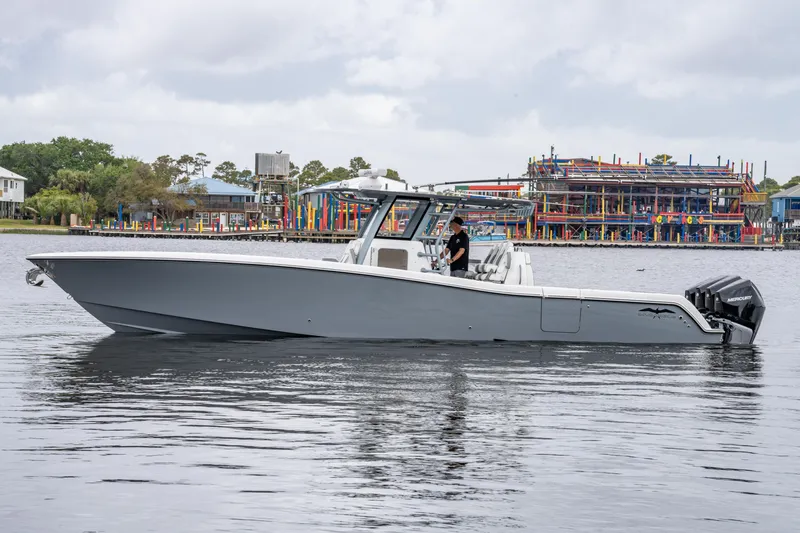 Slide: The Image of 2022 Invincible 39 Open Fisherman boat on calm water near colorful waterfront buildings. - 9