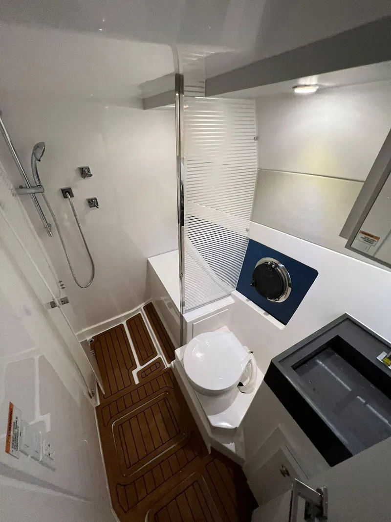 Slide: The Image of Modern bathroom in 2023 Evolve 400HT yacht with shower, toilet, and wooden flooring. - 11