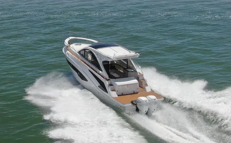 Slide: The Image of 2023 Evolve 400HT boat cruising on open water, showcasing sleek design and powerful engines. - 15