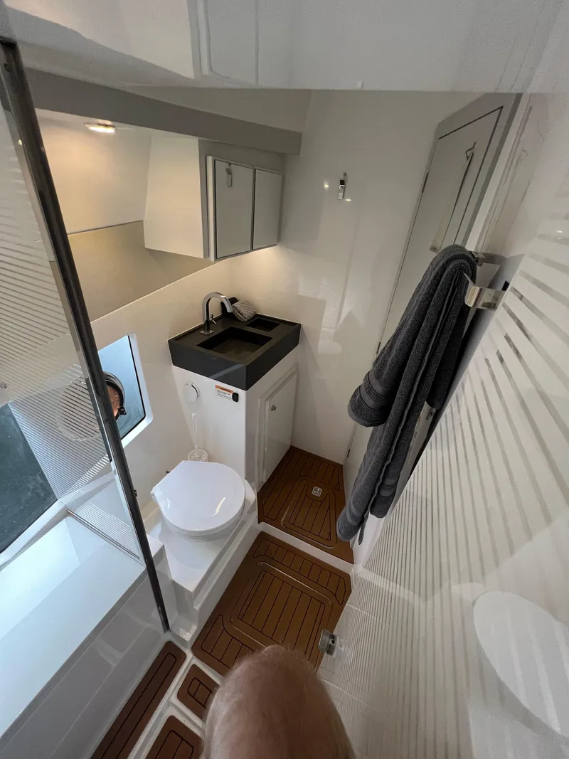 Slide: The Image of Modern bathroom in 2023 Evolve 400HT yacht with sleek fixtures and wooden flooring. - 19