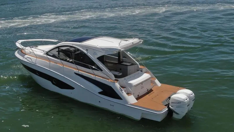 Slide: The Image of 2023 Evolve 400HT luxury boat cruising on open water. - 2