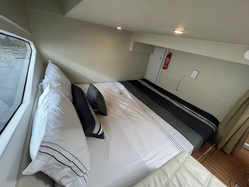 Slide: The Image of Luxurious cabin interior of 2023 Evolve 400HT yacht with cozy bed and window view. - 26