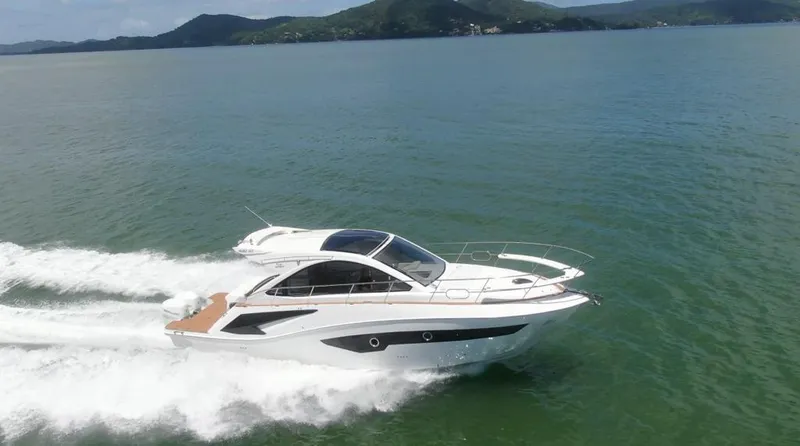 Slide: The Image of 2023 Evolve 400HT yacht cruising on open water, showcasing sleek design and performance. - 4