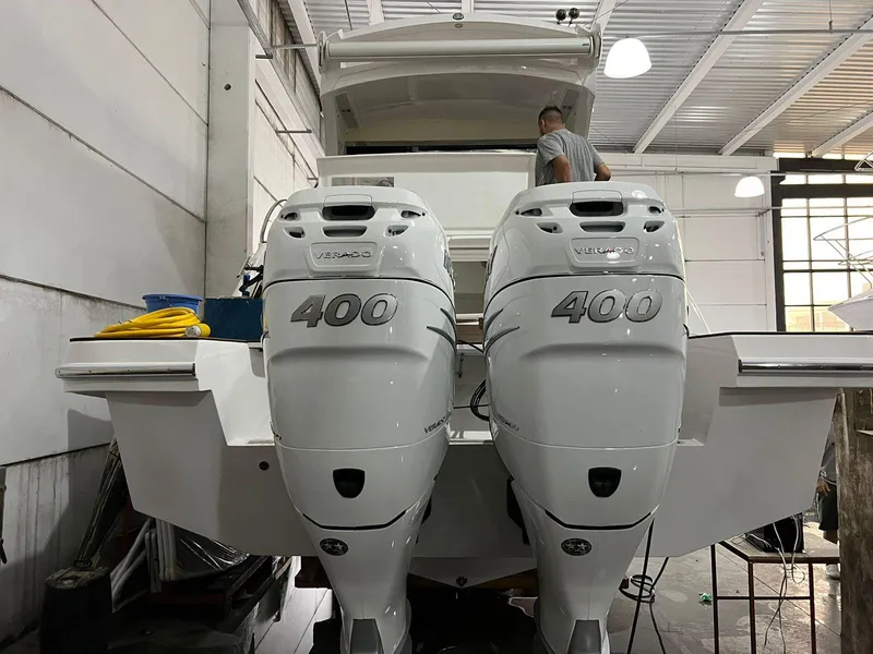 Slide: The Image of 2023 Evolve 400HT boat with dual 400 horsepower engines in a garage setting. - 5