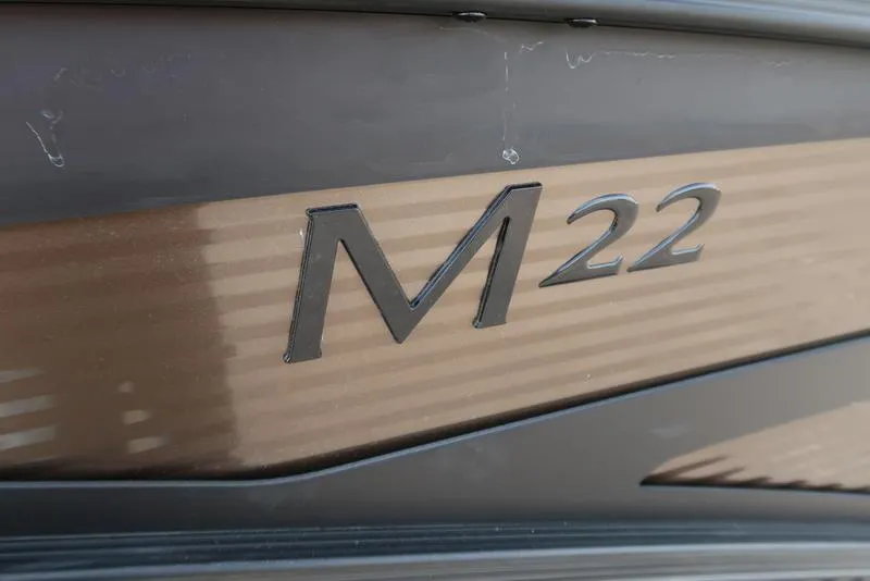 Slide: The Image of Close-up of Bennington M Quad Bench 22 MFB, 2025 model, showcasing 'M22' emblem. - 11