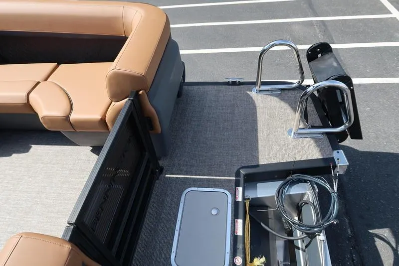 Slide: The Image of 2025 Bennington M Quad Bench 22 MFB boat interior with tan seating and metal fixtures. - 18