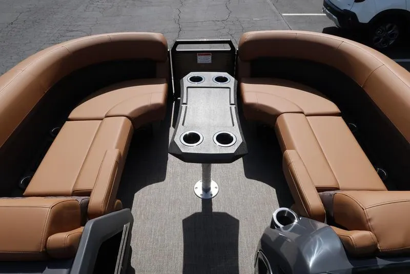 Slide: The Image of 2025 Bennington M Quad Bench 22 MFB with tan seating and central table, ideal for leisure. - 19