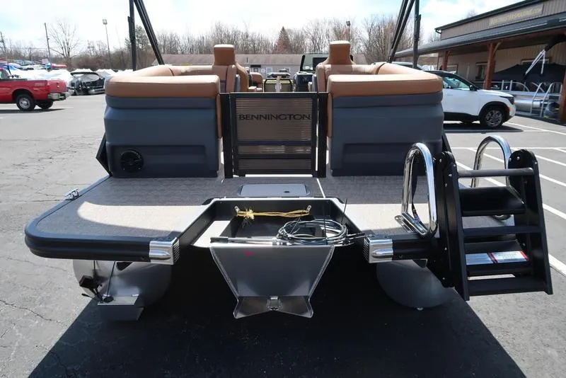 Slide: The Image of 2025 Bennington M Quad Bench 22 MFB pontoon boat, rear view with seating and ladder. - 2