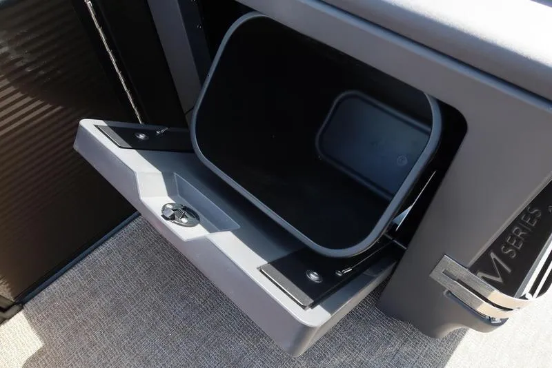 Slide: The Image of Open storage compartment in 2025 Bennington M Quad Bench 22 MFB boat. - 22