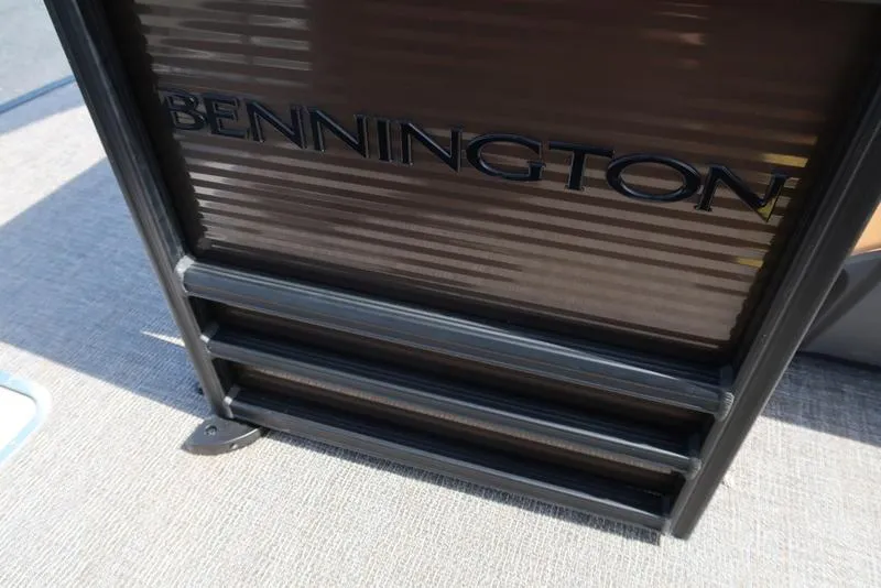 Slide: The Image of Bennington M Quad Bench 22 MFB 2025, close-up of boat detail with logo. - 26
