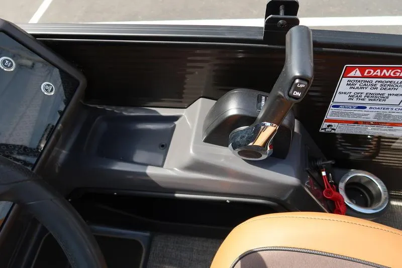 Slide: The Image of Control panel of 2025 Bennington M Quad Bench 22 MFB with throttle lever and warning label. - 39