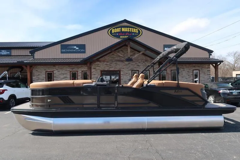 Slide: The Image of 2025 Bennington M Quad Bench 22 MFB pontoon boat parked at Boat Masters dealership. - 4