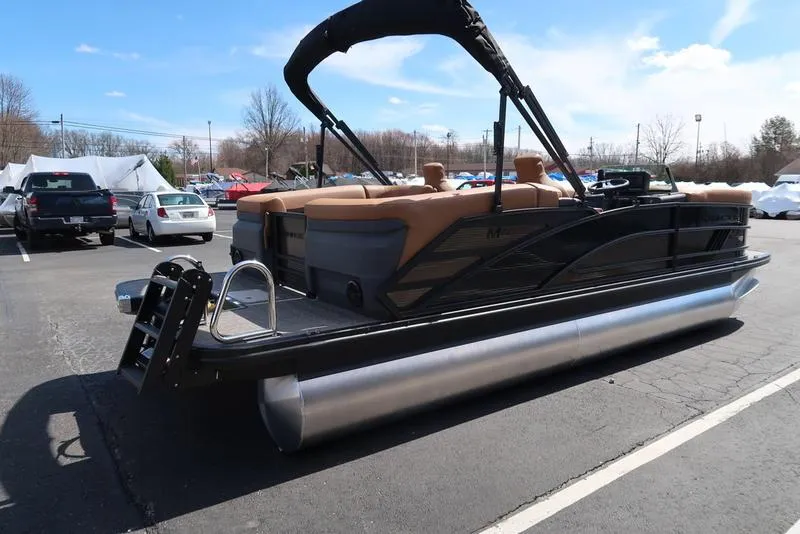 Slide: The Image of 2025 Bennington M Quad Bench 22 MFB pontoon boat in parking lot, side view. - 7