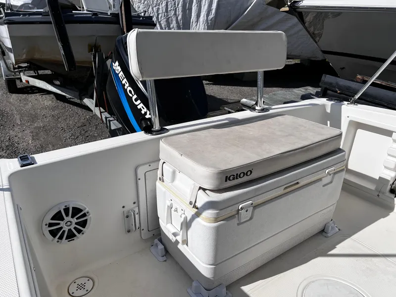 Slide: The Image of 2001 Aquasport 190 Osprey boat interior with Igloo cooler and Mercury engine. - 6