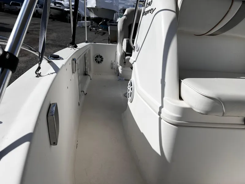 Slide: The Image of 2001 Aquasport 190 Osprey boat interior, featuring white seating and deck area. - 9
