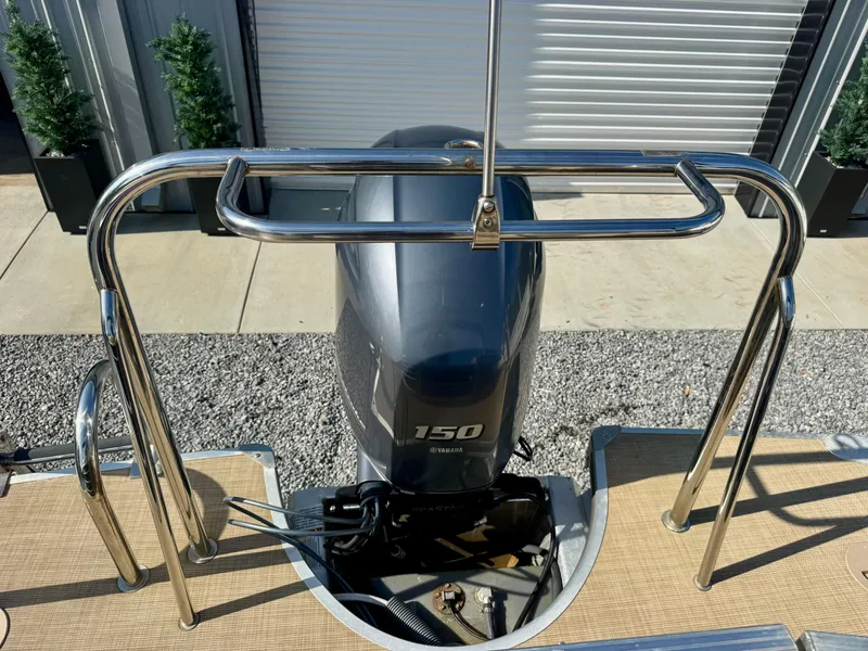 Slide: The Image of 2018 South Bay 500 Series 2.75 boat with 150 horsepower engine, docked outdoors. - 11