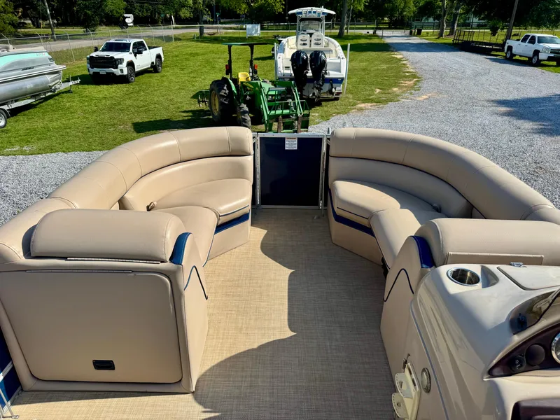 Slide: The Image of 2018 South Bay 500 Series 2.75 pontoon boat interior with beige seating and open deck. - 9