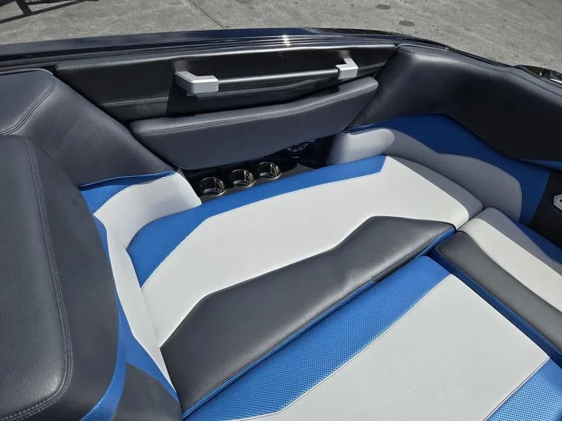 Slide: The Image of 2019 Supra SA boat interior with blue, gray, and white seating. - 12