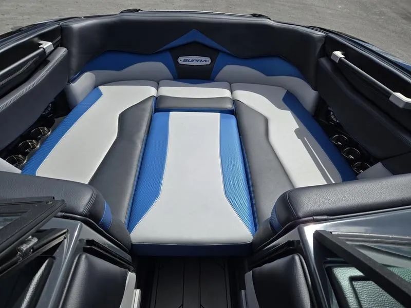 Slide: The Image of 2019 Supra SA boat interior with blue and gray seating, showcasing luxury design. - 13