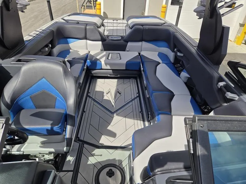Slide: The Image of 2019 Supra SA boat interior with blue and gray seating, modern design, and spacious layout. - 15