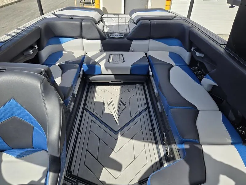 Slide: The Image of 2019 Supra SA boat interior with blue and gray seating, showcasing modern design and spacious layout. - 17