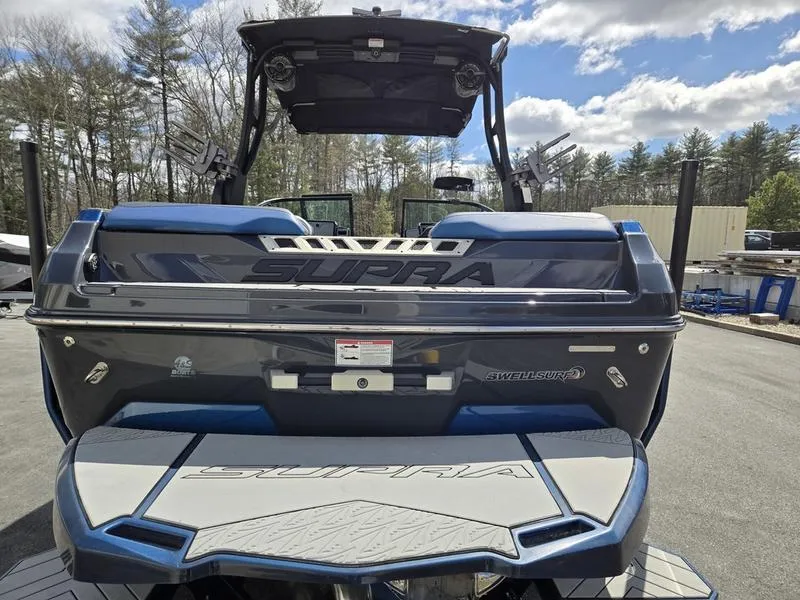 Slide: The Image of 2019 Supra SA boat rear view with swim platform, parked outdoors. - 5