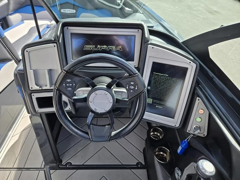 Slide: The Image of 2019 Supra SA boat dashboard with steering wheel and digital displays. - 6