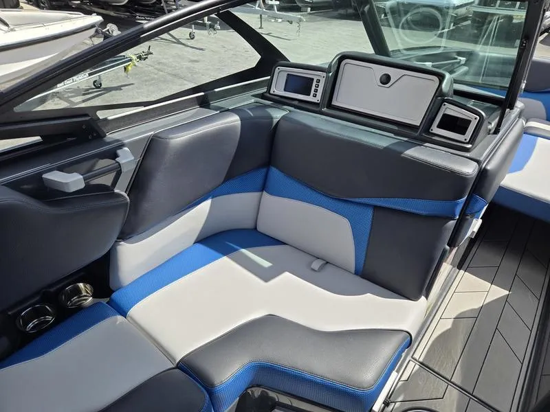 Slide: The Image of 2019 Supra SA boat interior with blue and gray seating, modern dashboard, and sleek design. - 7