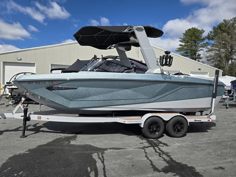 Slide: The Image of 2022 Nautique Super Air Nautique G23 boat on trailer, parked outdoors. - 1