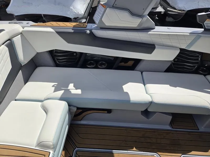 Slide: The Image of 2022 Nautique Super Air Nautique G23 interior with white seating and wood accents. - 13