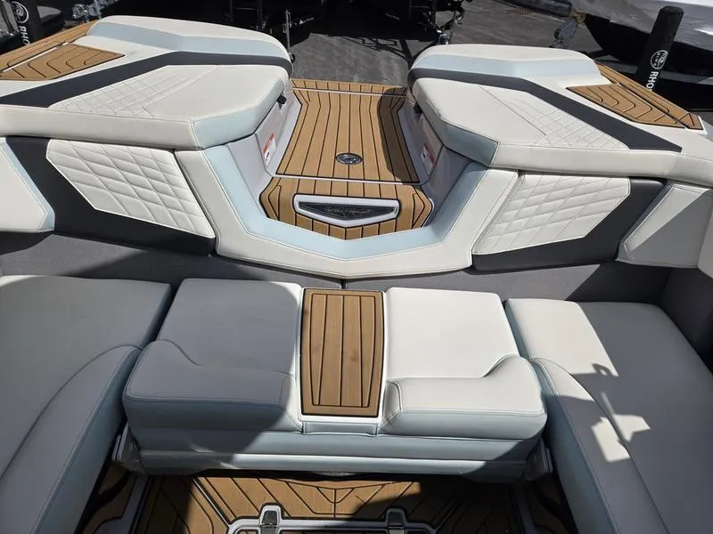 Slide: The Image of 2022 Nautique Super Air Nautique G23 interior with luxurious seating and teak flooring. - 14