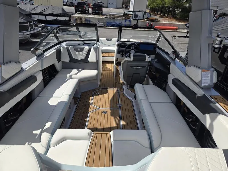 Slide: The Image of 2022 Nautique Super Air Nautique G23 boat interior with luxurious seating and modern dashboard. - 16