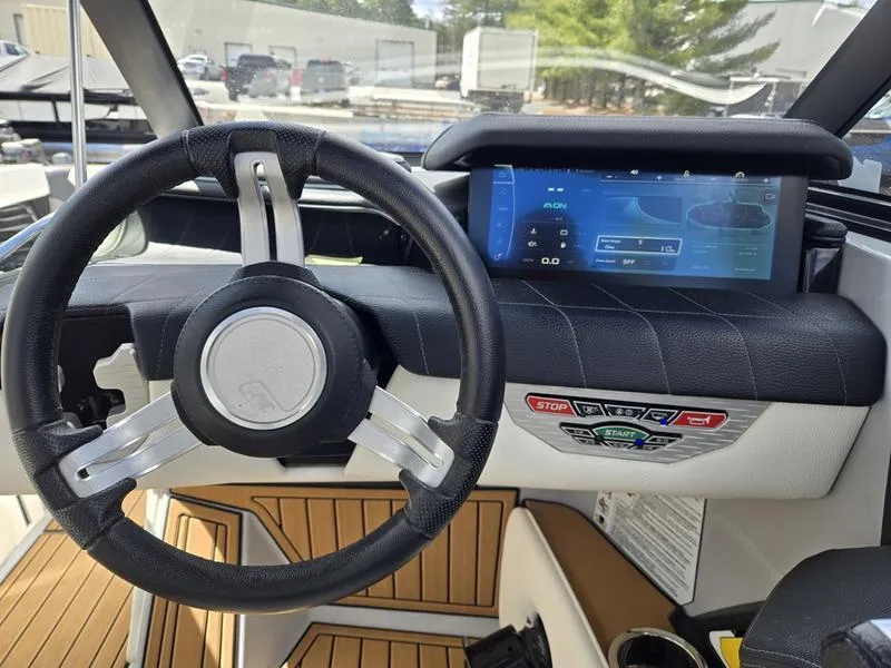 Slide: The Image of 2022 Nautique Super Air Nautique G23 dashboard with steering wheel and digital display. - 19