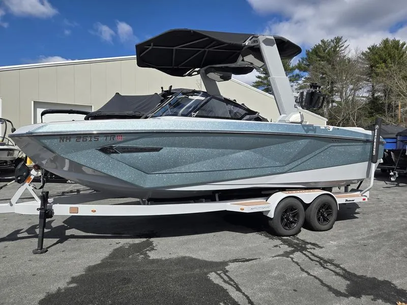 Slide: The Image of 2022 Nautique Super Air Nautique G23 boat on trailer, parked outdoors. - 2