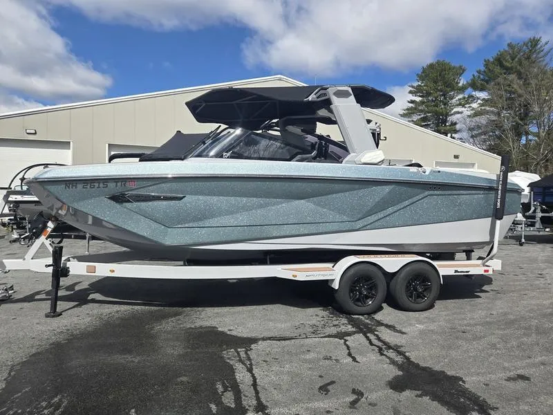 Slide: The Image of 2022 Nautique Super Air Nautique G23 boat on trailer, parked outdoors. - 22