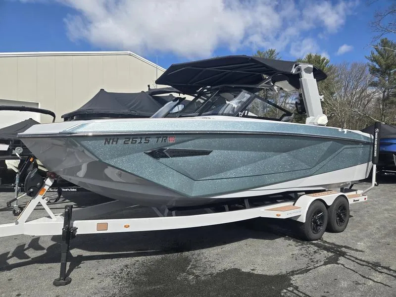 Slide: The Image of 2022 Nautique Super Air Nautique G23 boat on trailer, parked outdoors. - 3