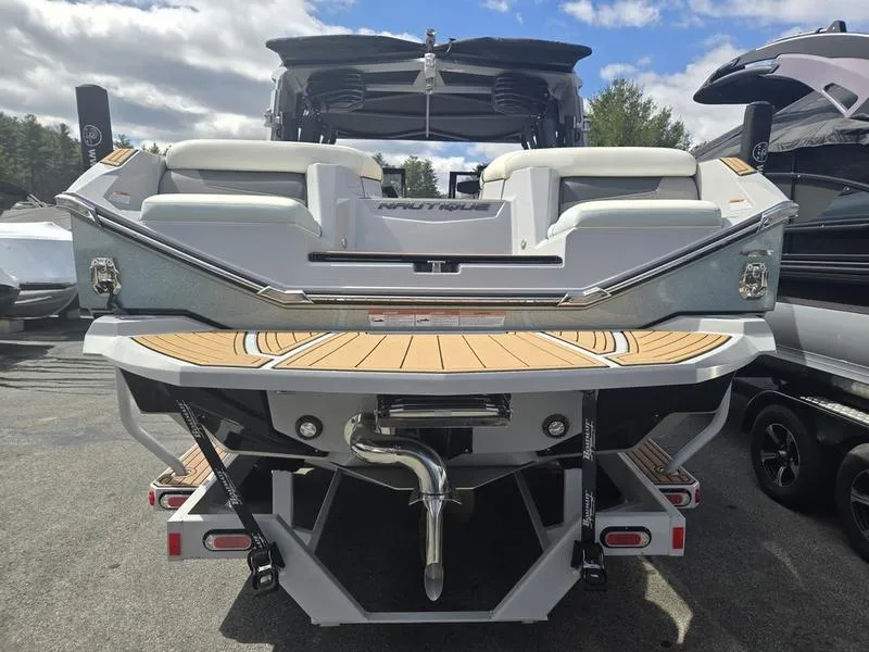 Slide: The Image of 2022 Nautique Super Air Nautique G23 boat, rear view, showcasing sleek design and spacious seating. - 6