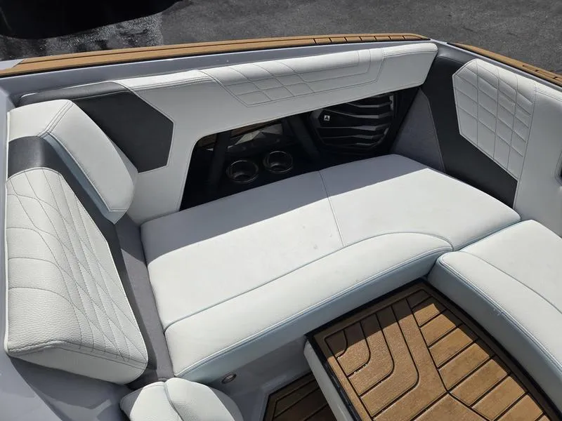 Slide: The Image of 2022 Nautique Super Air Nautique G23 interior with white leather seating and teak flooring. - 9