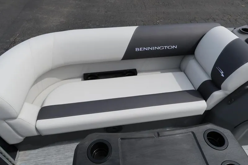 Slide: The Image of 2025 Bennington S Quad Bench 20 SSR boat seating, featuring sleek white and gray upholstery. - 11