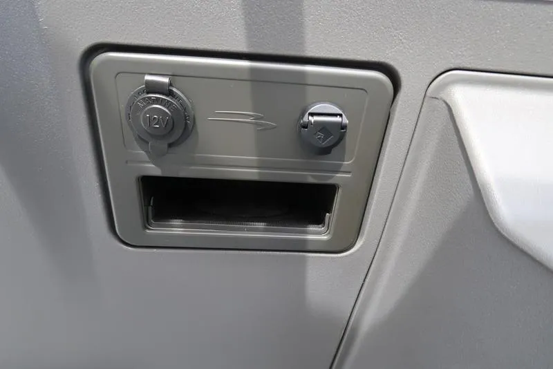 Slide: The Image of 12V power outlet and accessory port on 2025 Bennington S Quad Bench 20 SSR. - 19