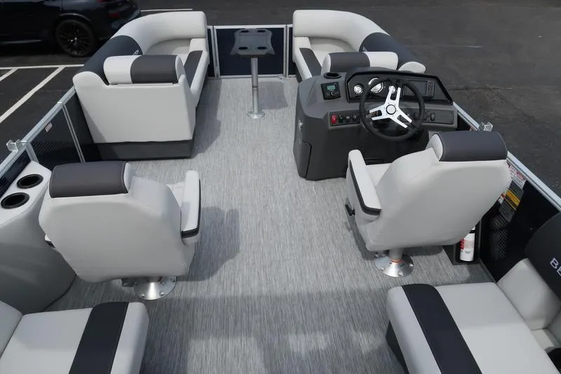 Slide: The Image of 2025 Bennington S Quad Bench 20 SSR pontoon boat interior with modern seating and steering console. - 2