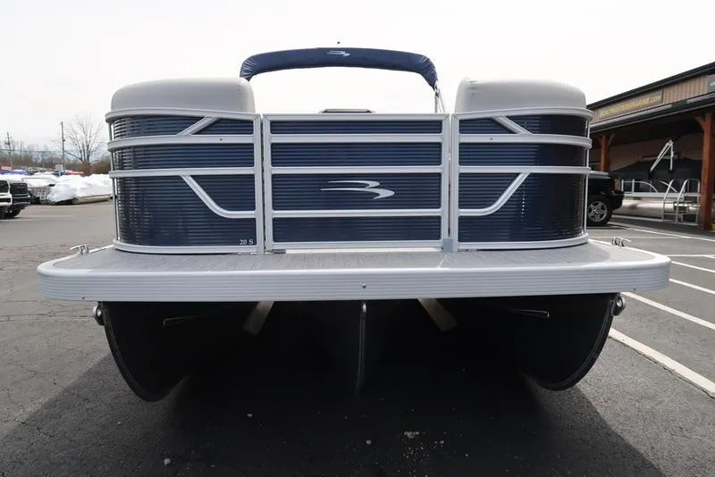 Slide: The Image of 2025 Bennington S Quad Bench 20 SSR pontoon boat, front view in parking lot. - 4