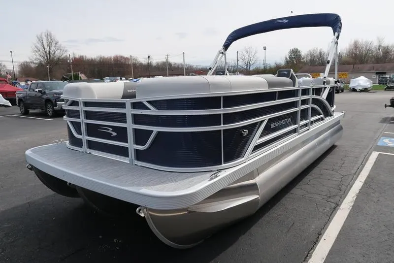 Slide: The Image of 2025 Bennington S Quad Bench 20 SSR pontoon boat in parking lot. - 5