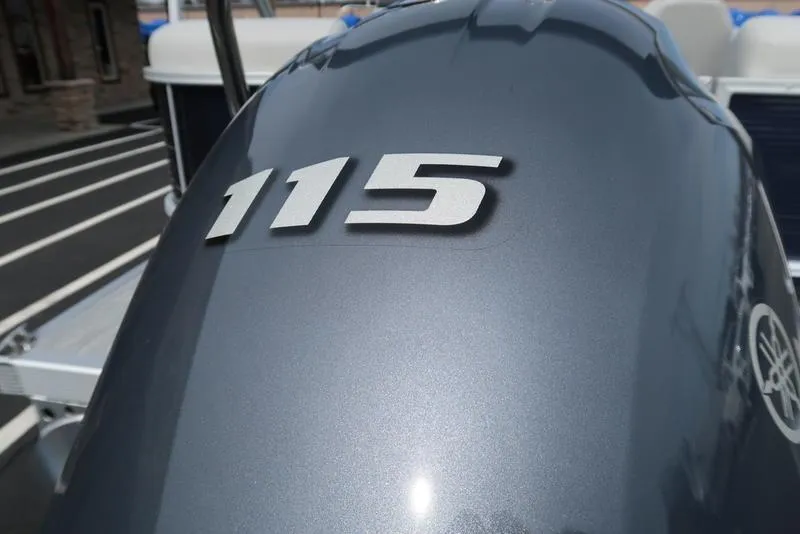 Slide: The Image of Close-up of 2025 Bennington S Quad Bench 20 SSR outboard motor with '115' marking. - 9